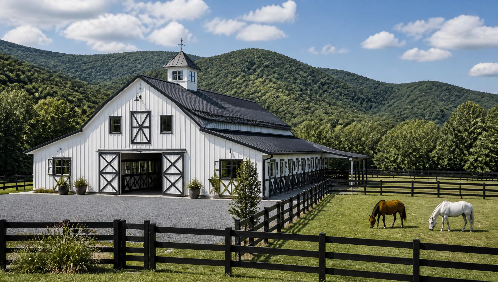 White horse barn with fenced paddocks on a North Georgia equestrian property