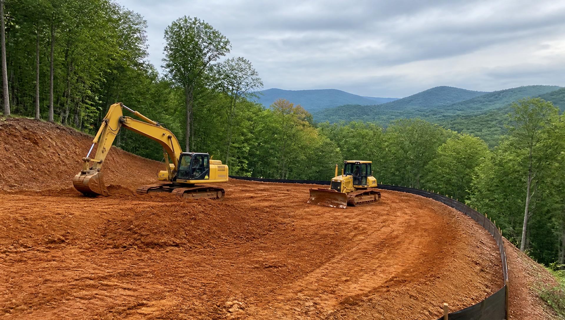 Excavator grading a building pad on a wooded North Georgia acreage property